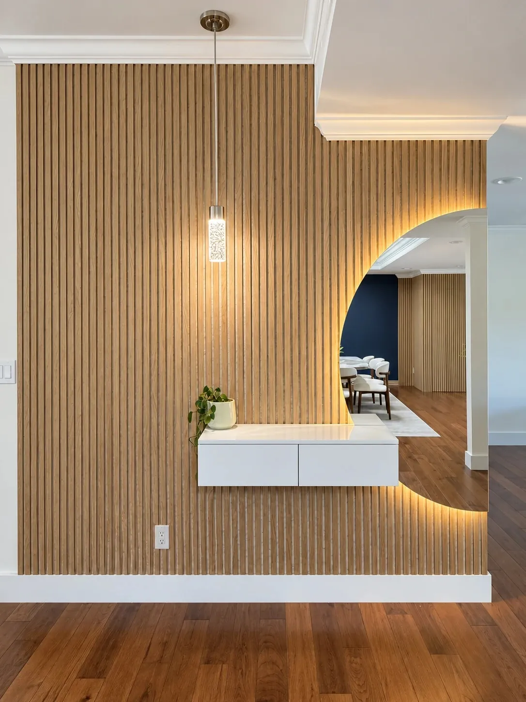 Light-oak slat feature wall with a backlit arched opening and floating console
